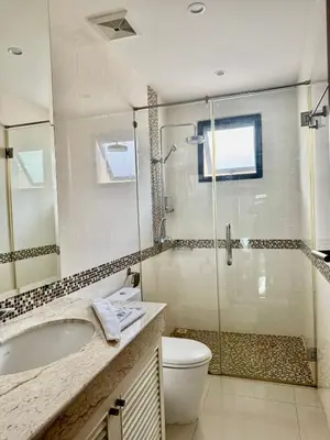 a bathroom with a shower and a sink and a toilet at Stunning 2-Bedroom Pool Villa in Ban Thalat Choeng Thale