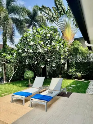 two lounge chairs with blue cushions on a patio at Stunning 2-Bedroom Pool Villa in Ban Thalat Choeng Thale