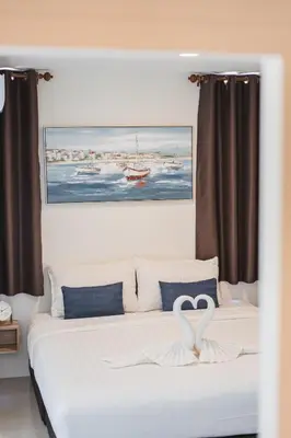 a bedroom with a bed with a heart on it at 24sqm room close to beach and Muay Thai gym in Ao Nang Beach