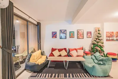 a living room with a couch and a christmas tree at 24sqm room close to beach and Muay Thai gym in Ao Nang Beach