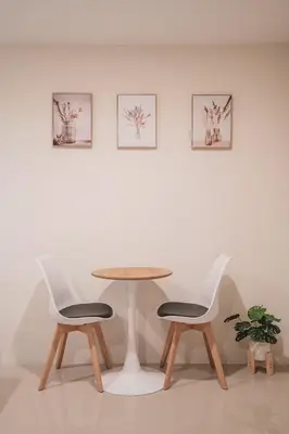 a table and two chairs in a white room at 24sqm room close to beach and Muay Thai gym in Ao Nang Beach