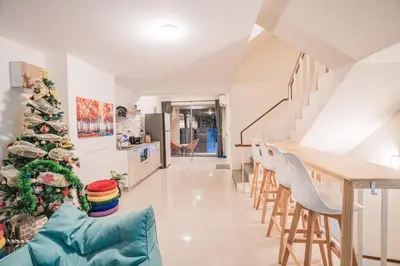 a christmas tree in a living room with a table and chairs at 24sqm room close to beach and Muay Thai gym in Ao Nang Beach