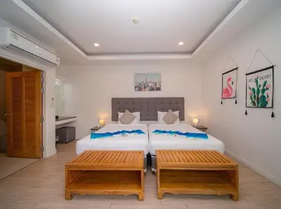 a bedroom with two beds and two benches at \u6cf0\u56fd\u666e\u5409\u5c9bYona\u6d77\u8fb9\u56db\u5367\u5ba43\u53f7 in Ban Bang La