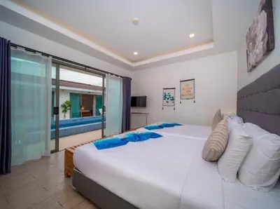a bedroom with a large white bed and a large window at \u6cf0\u56fd\u666e\u5409\u5c9bYona\u6d77\u8fb9\u56db\u5367\u5ba43\u53f7 in Ban Bang La