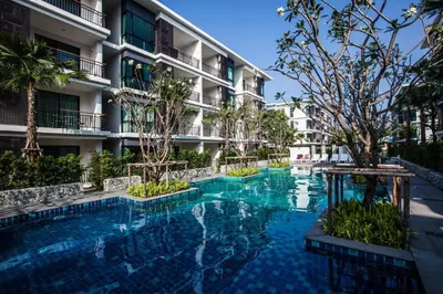 a swimming pool in front of a building at Rawai beach 1br apartment at The Title in Rawai Beach