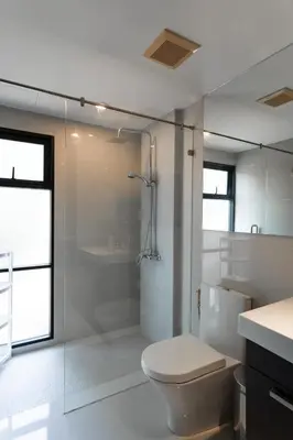 a white bathroom with a toilet and a shower at Rawai beach 1br apartment at The Title in Rawai Beach