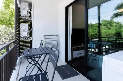 a patio with a table and chairs on a balcony at Rawai beach 1br apartment at The Title in Rawai Beach
