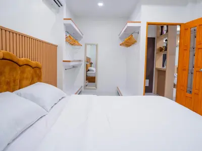 a bedroom with a large white bed and a closet at 3 Bedroom Villa with Pool near Fitness street in Ban Klang