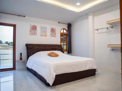 a bedroom with a large bed in a white room at 3 Bedroom Villa with Pool near Fitness street in Ban Klang