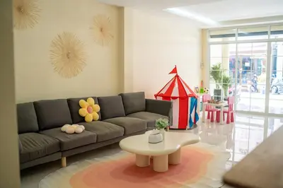a living room with a couch and a table at Beachfront 4-BR House in Patong in Patong Beach