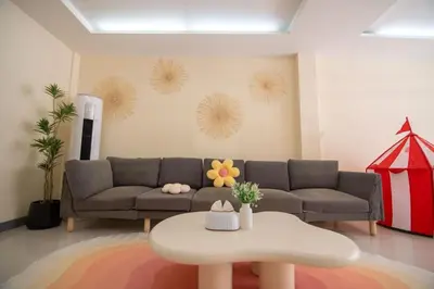 a living room with a couch and a table at Beachfront 4-BR House in Patong in Patong Beach