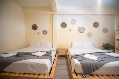 two beds in a room with plates on the wall at Beachfront 4-BR House in Patong in Patong Beach