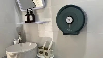 a bathroom with a sink and bottles of wine at Suntalee House in Nai Yang Beach