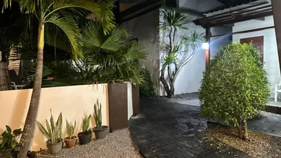 a courtyard with potted plants in a building at Suntalee House in Nai Yang Beach