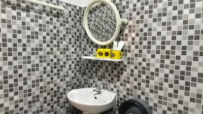 a bathroom with a sink and a mirror at Suntalee House in Nai Yang Beach