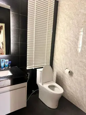a bathroom with a white toilet and a sink at Luxury 2-Bedroom Penthouse with Seaview Kamala in Kamala Beach