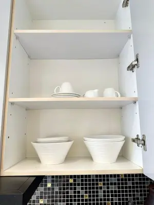 a cupboard with two bowls and plates on it at Luxury 2-Bedroom Penthouse with Seaview Kamala in Kamala Beach