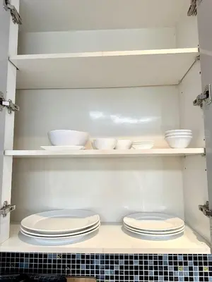 a kitchen with plates and bowls on shelves at Luxury 2-Bedroom Penthouse with Seaview Kamala in Kamala Beach