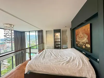 a bedroom with a large bed and a balcony at Luxury 2-Bedroom Penthouse with Seaview Kamala in Kamala Beach