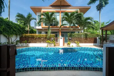 a swimming pool in front of a house at AP Nest Villas Residence - Tropical Pool Access, near Kamala Beach in Kamala Beach