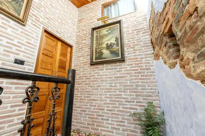 a brick building with a door and a picture on the wall at Twelve 8 Boutique House in Phuket Town