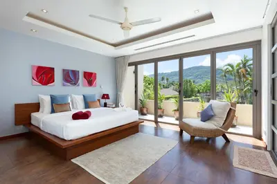 a bedroom with a large bed and a balcony at The Residence Bangtao Villa 216 in Bang Tao Beach