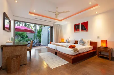 a bedroom with a king sized bed and a desk at The Residence Bangtao Villa 216 in Bang Tao Beach