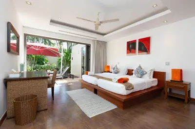 a bedroom with a king sized bed and a desk at The Residence Bangtao Villa 216 in Bang Tao Beach