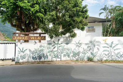 a white wall with a mural of palm trees on it at Jungle Villa-private pool, BBQ near Kamala beach in Kamala Beach