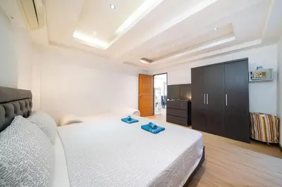 a bedroom with a bed with two blue towels on it at Jungle Villa-private pool, BBQ near Kamala beach in Kamala Beach