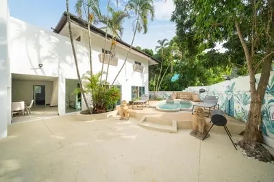 a patio with two dogs and a pool at Jungle Villa-private pool, BBQ near Kamala beach in Kamala Beach