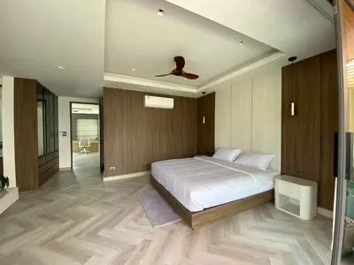 a bedroom with a white bed and a ceiling at Mountain breeze villa phuket in Ban Bang Khu