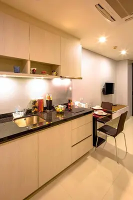 a kitchen with a counter and a table in it at At the tree by fatimah Rawai R315 in Rawai Beach