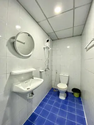 a bathroom with a toilet and a sink and a mirror at Mini Thai Guesthouse Patong in Patong Beach