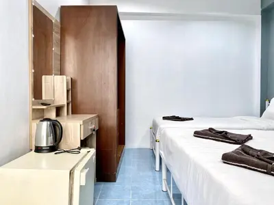 a hotel room with two beds at Mini Thai Guesthouse Patong in Patong Beach