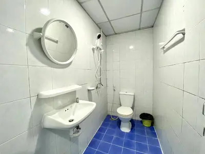 a bathroom with a sink and a mirror and a toilet at Mini Thai Guesthouse Patong in Patong Beach