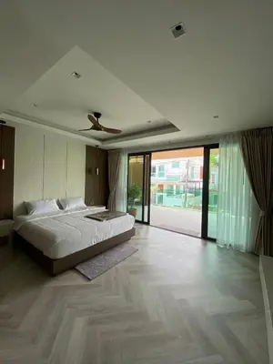 a bedroom with a bed and a ceiling fan at Mountain breeze villa phuket in Ban Bang Khu