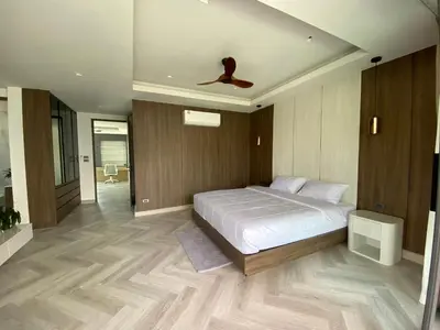 a bedroom with a bed and a ceiling fan at Mountain breeze villa phuket in Ban Bang Khu
