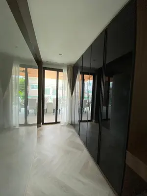 a living room with glass doors and a floor at Mountain breeze villa phuket in Ban Bang Khu