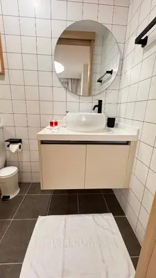 a white bathroom with a sink and a mirror at Fantasea Condo Kamala beach 1BR apart B1 in Kamala Beach