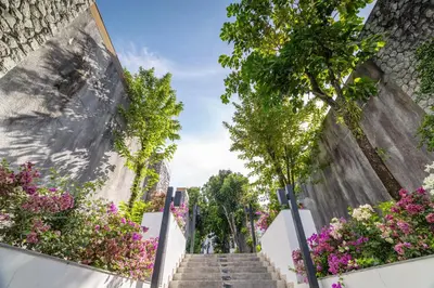 a stairway with flowers on the side of a building at Phuket Moonlit Bay Seaview Resort & Spa in Phuket Town