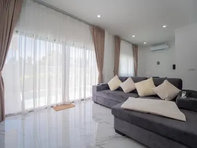 a living room with a couch and a large window at Leivi Villa 3 bedrooms in Rawai Beach
