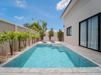 a swimming pool in the backyard of a house at Leivi Villa 3 bedrooms in Rawai Beach