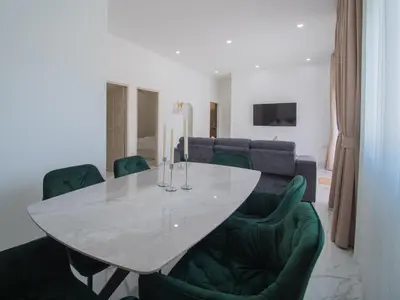 a dining room with a white table and green chairs at Leivi Villa 3 bedrooms in Rawai Beach