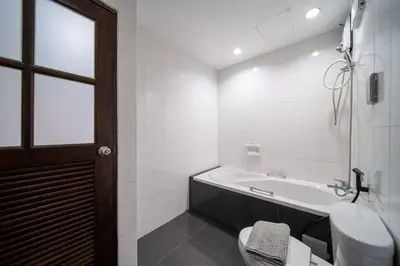a bathroom with a tub and a toilet and a sink at PatongTower\u6b65\u884c\u76f4\u8fbe\u6d77\u6ee9\u9ad8\u901fwifi605S in Patong Beach