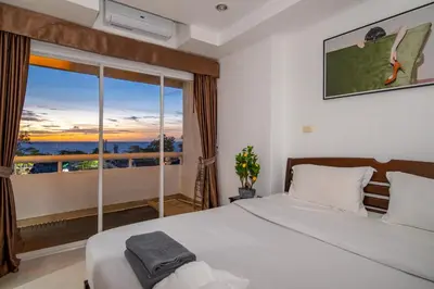 a bedroom with a bed and a large window at PatongTower\u6b65\u884c\u76f4\u8fbe\u6d77\u6ee9\u9ad8\u901fwifi605S in Patong Beach