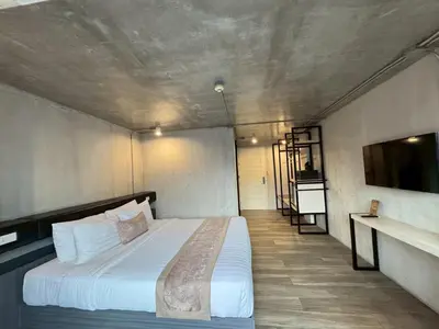 a bedroom with a large bed in a room at Aspira Central Patong in Patong Beach