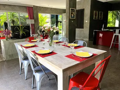a dining room table with chairs and a large wooden table at 11 - Peaceful Escape on Naiyang Beach in Nai Yang Beach