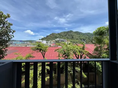 a balcony with a view of a roof at Patong city-center pool cozy condo in Patong Beach