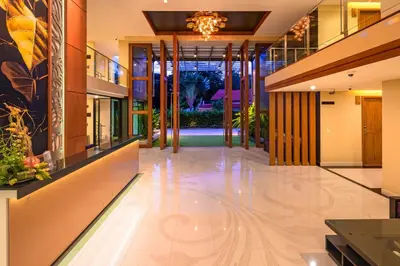 an empty lobby of a building with a chandelier at At the tree by fatimah Rawai 408 in Rawai Beach